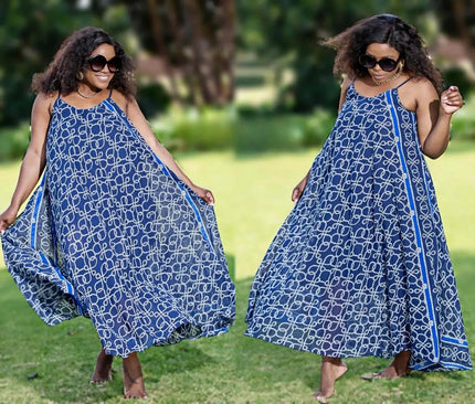 Blue sleeveless maxi dress with white chain-link pattern, flared hem and spaghetti straps