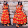 Orange floral maxi dress with V-neck, tied shoulder straps, and tiered skirt