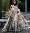 Sleeveless maxi dress with tropical leaf print, cream base and dark foliage