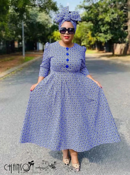 Blue African print midi dress with geometric pattern, flared sleeves, button front