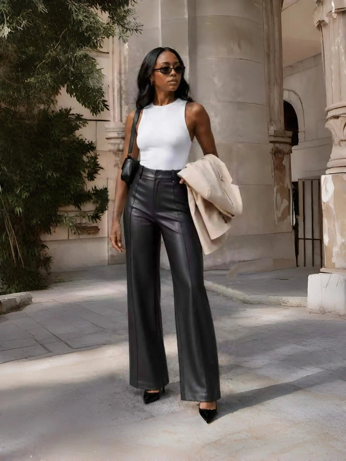 Black high-waist tailored wide-leg pants with crease seams and belt loops