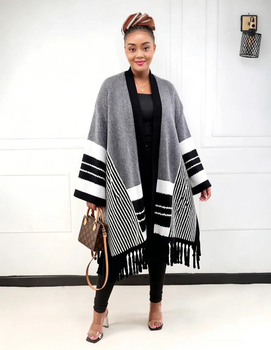 Striped knit cardigan poncho with fringe trim, open front, black and white bands