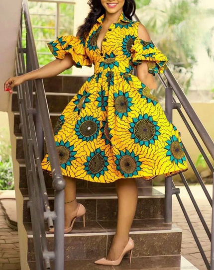 Off-shoulder midi dress in yellow and teal with ruffled sleeves and circular motifs