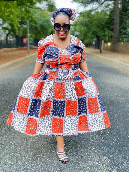 Plus size geometric midi dress with puff sleeves, patchwork orange, blue, and white