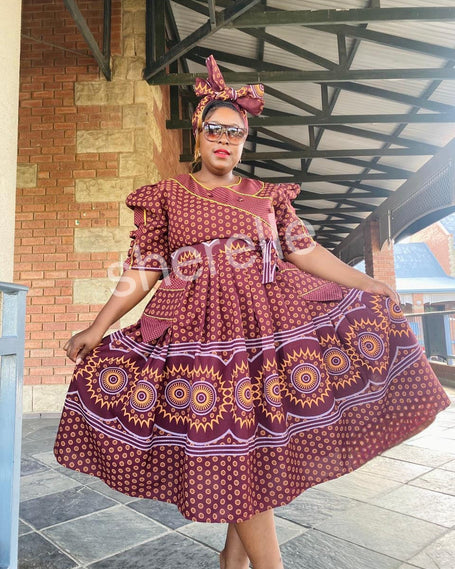 Burgundy patterned A-line midi dress with puff sleeves, round neckline, tiered skirt