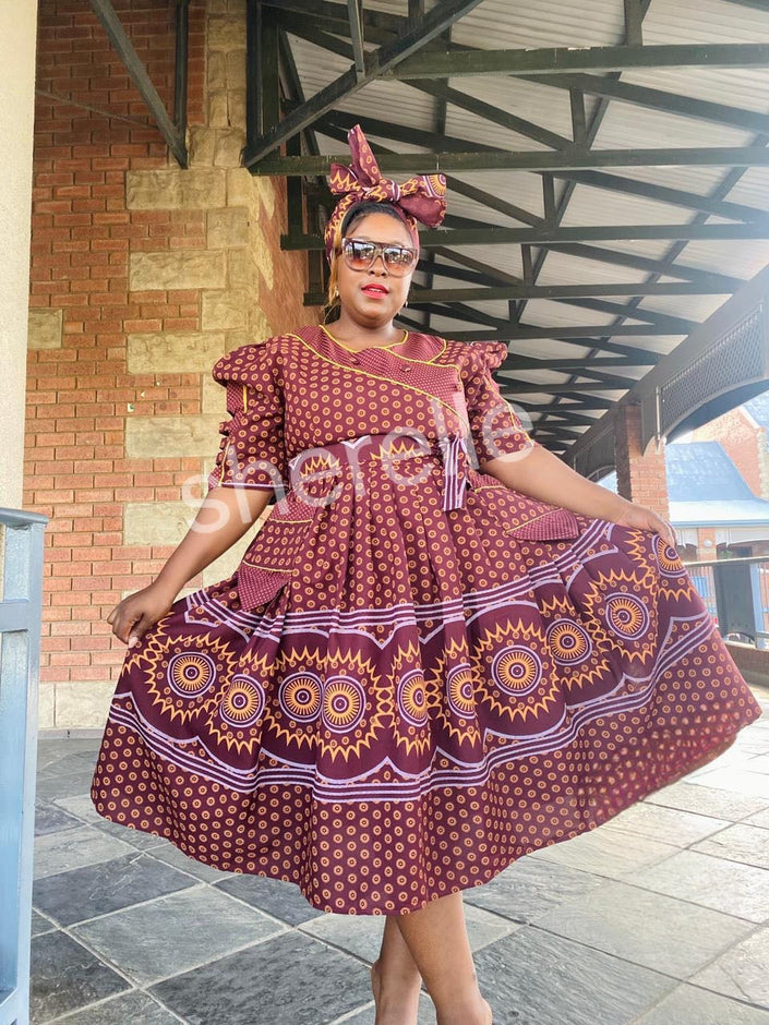 Burgundy patterned A-line midi dress with puff sleeves, round neckline, tiered skirt