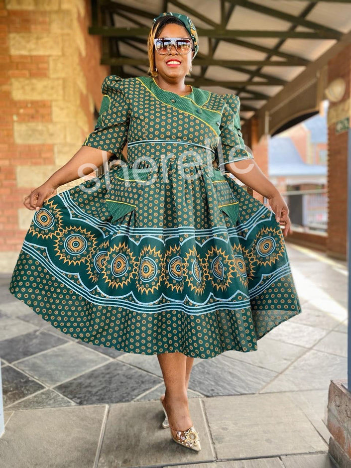 Green A-line midi dress with puff sleeves, round neckline, bold circular border print