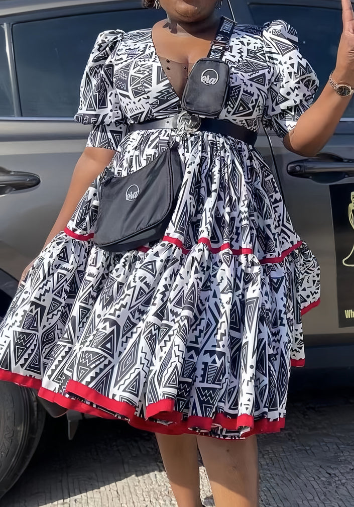 Geometric midi dress with puff sleeves, black-and-white print, red trim hem