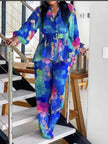 Women’s matching blouse and trousers set with vibrant multicolor geometric print, long sleeves