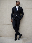 Men's slim-fit suit with notched lapels, dark trousers, and matching jacket