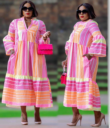Geometric midi dress with puff sleeves, pink and orange striped pattern, tiered hem