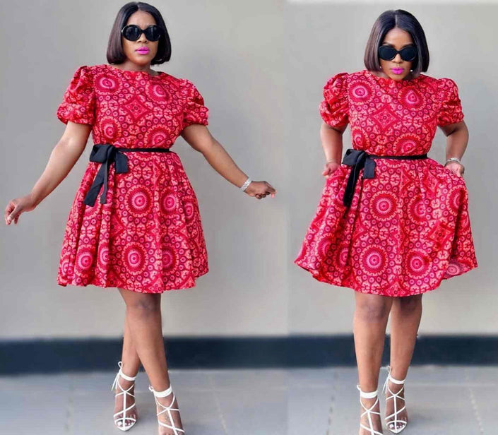 Red floral mini dress with puff sleeves, black waist belt, and flared skirt