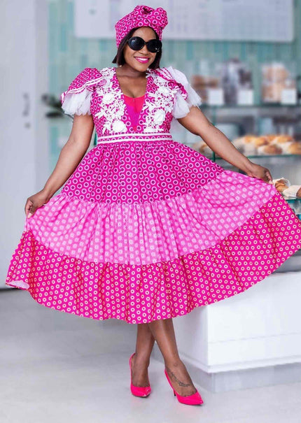 Pink puff-sleeve midi dress with lace trim and patterned bodice skirt
