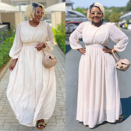 Cream maxi dress with cinched waist, puff sleeves, and subtle dot pattern