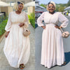 Cream maxi dress with cinched waist, puff sleeves, and subtle dot pattern