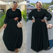 Black maxi dress with cinched waist and puff sleeves, subtle dotted texture