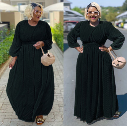 Black maxi dress with cinched waist and puff sleeves, subtle dotted texture