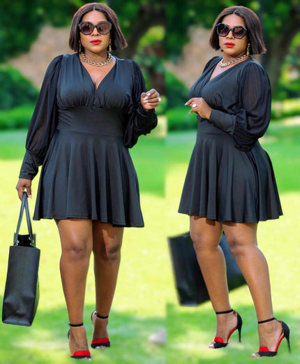 Dark V-neck skater dress with long flared sleeves, gathered waist, skater skirt.