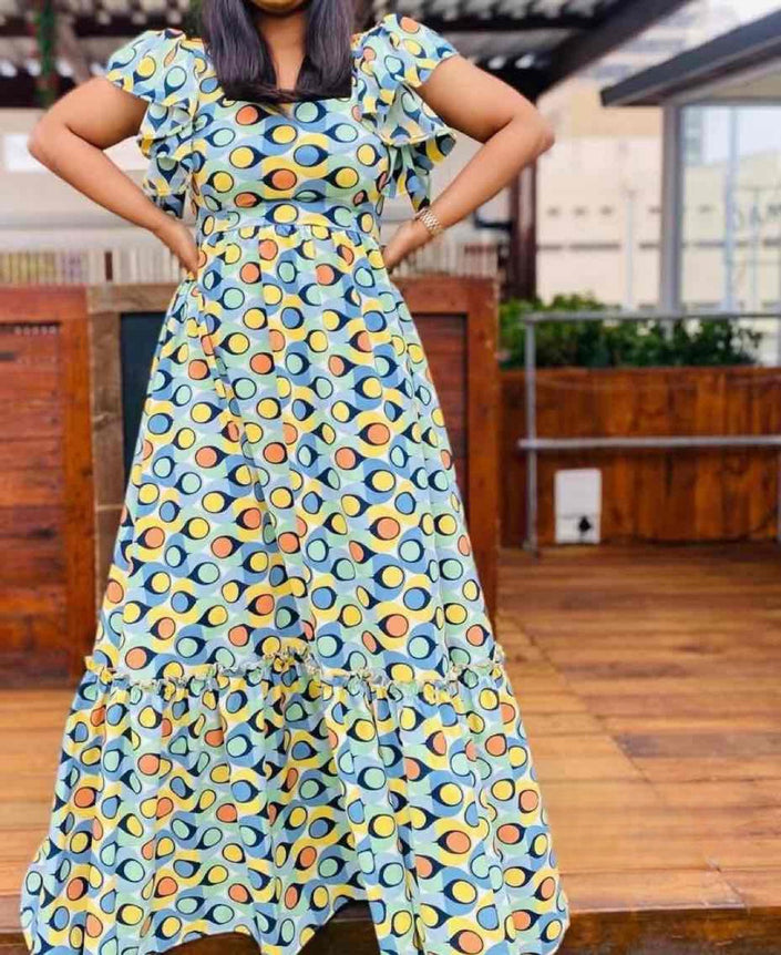 Flared maxi dress with short puff sleeves and colorful circular print, tiered ruffle hem