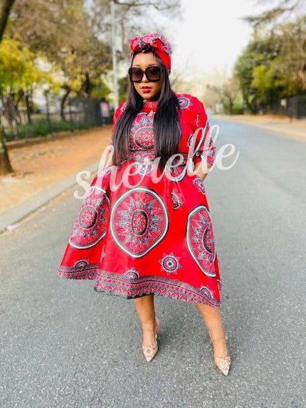 Red African print dress with matching headwrap, long sleeves and knee-length hem