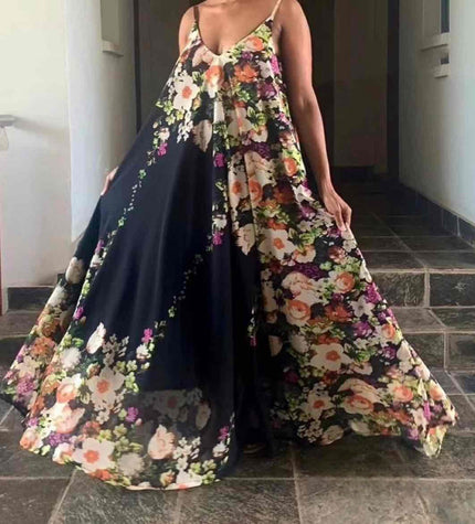 Floral maxi dress with spaghetti straps, flowing skirt, multicolor flowers on dark base.