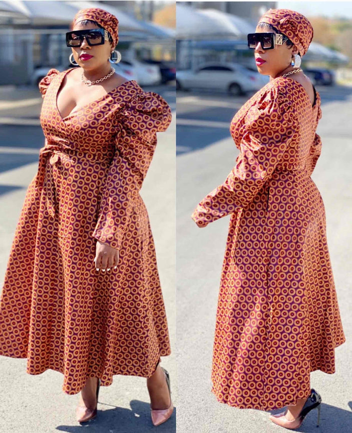 Belted V-neck puff-sleeve dress in rust patterned fabric with full skirt and waist tie