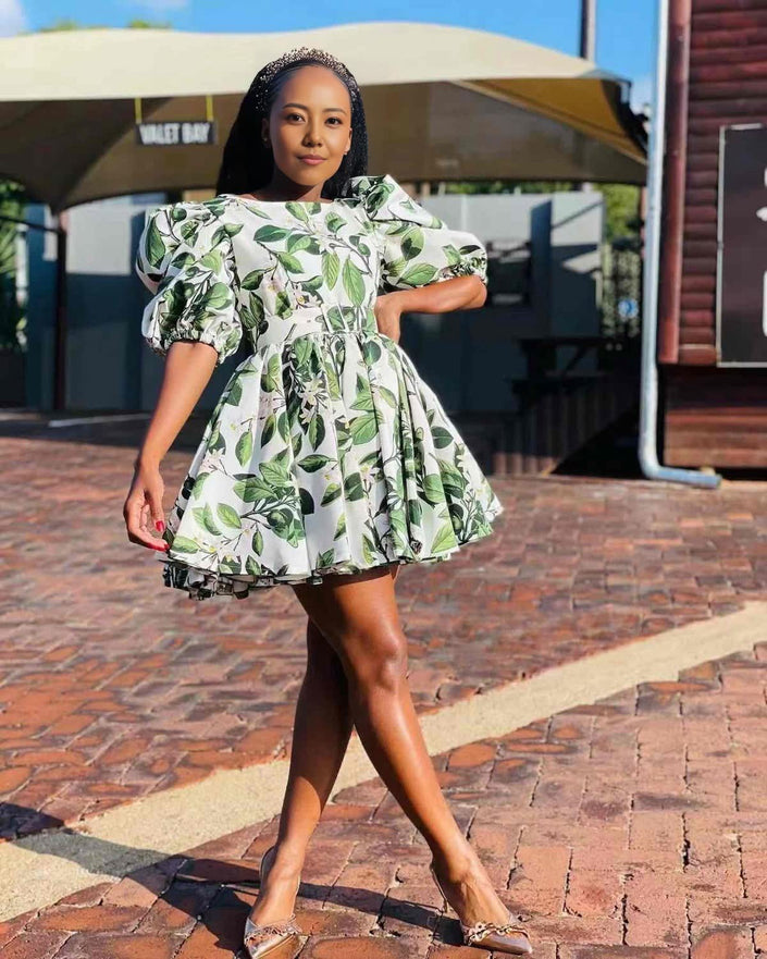 Leaf print mini A-line dress with puff sleeves, white with green foliage.