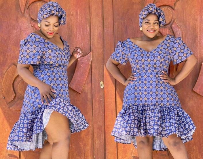 Blue puff-sleeve ruffle dress with circular print, fitted waist and flared skirt.