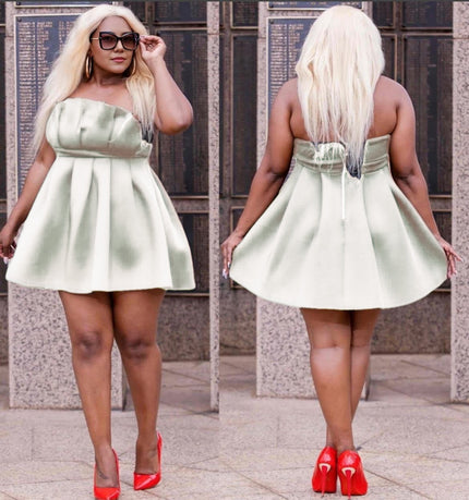 Light green strapless pleated mini dress with fitted bodice, back tie detail