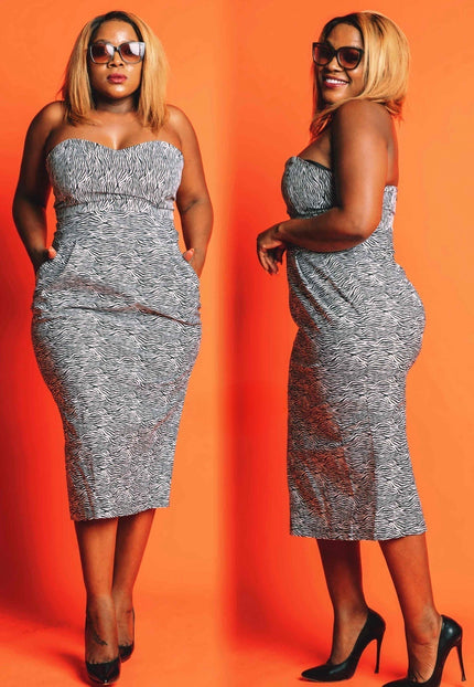 Strapless midi bodycon dress with ruched bust and black-and-white abstract pattern
