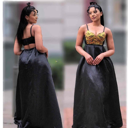 Black maxi dress with spaghetti straps and intricate corset-style bodice, full gathered skirt
