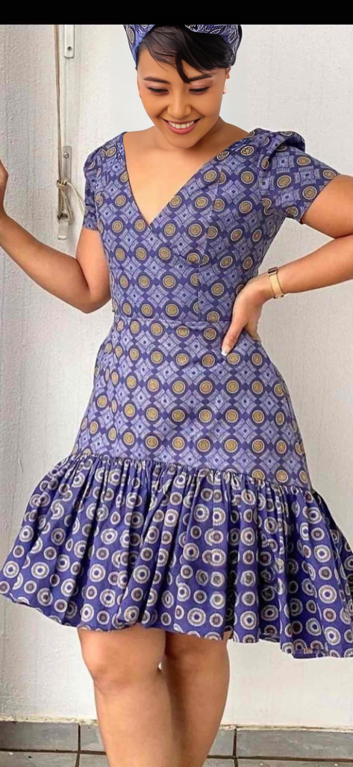 Printed mini dress with puff sleeves, V-neck, and ruffle hem; blue patterned