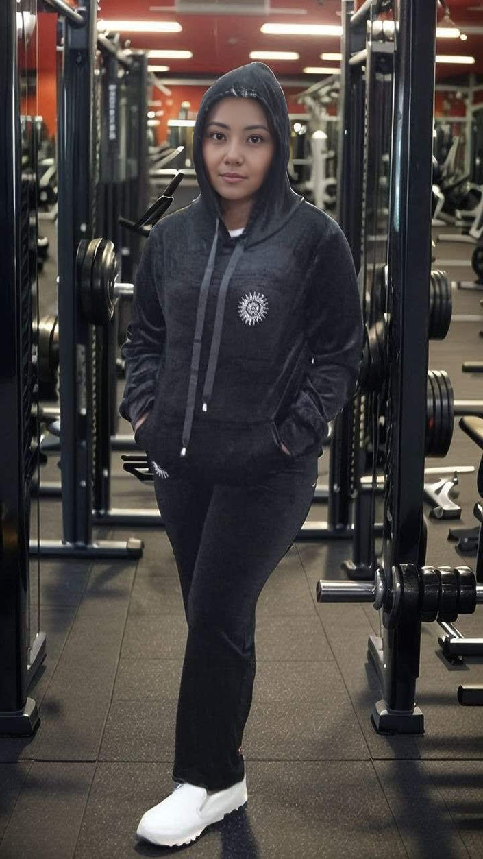 Dark hooded zip tracksuit set with drawstring and round chest emblem; matching pants