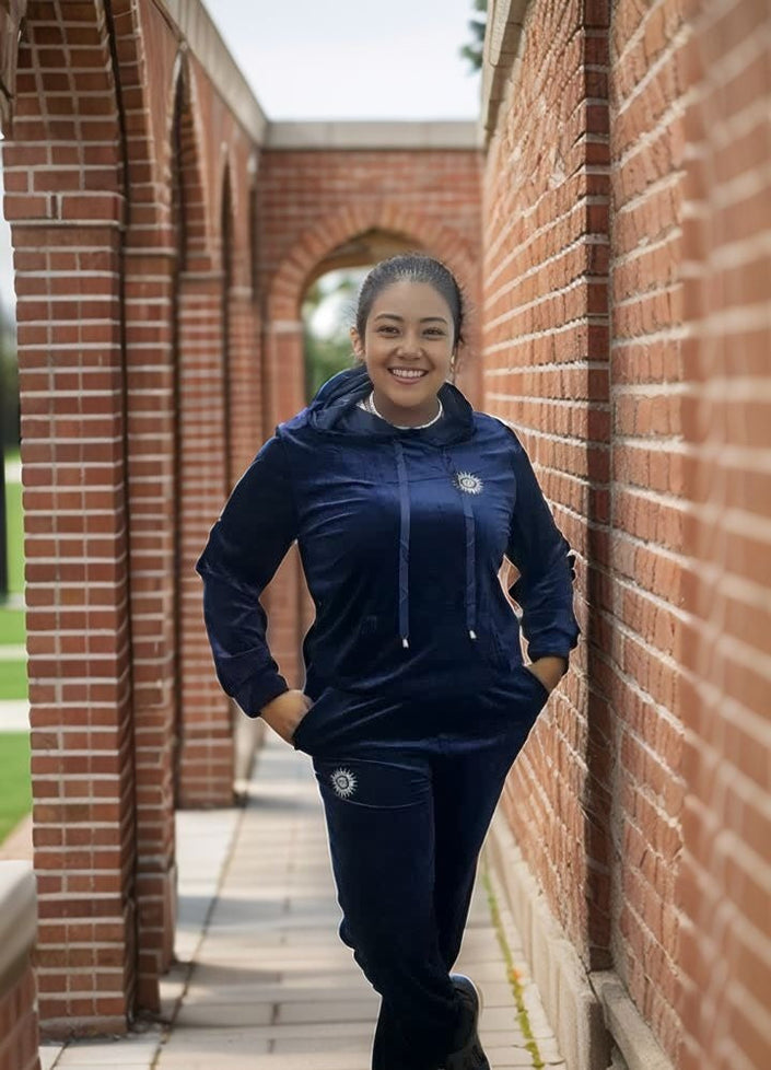 Navy hooded zip tracksuit set with drawstring and sun-style emblem; matching pants