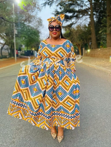 Geometric chevron maxi dress in yellow, blue, and white with short sleeves and flowing skirt
