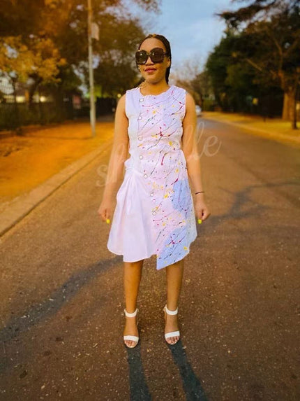 White sleeveless midi dress with flared skirt and colorful dotted floral print