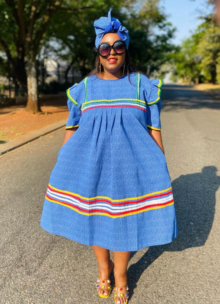 Sky-blue midi dress with matching headwrap and striped hem trim