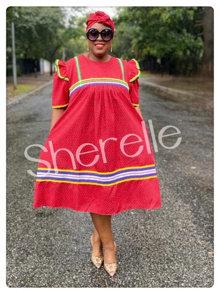Red midi dress with matching headwrap, short sleeves, and striped hem trim