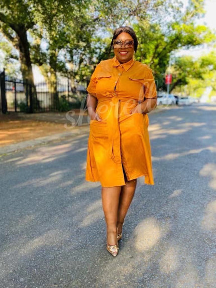 Orange shirt dress with tie waist, chest patch pockets, short sleeves, midi length