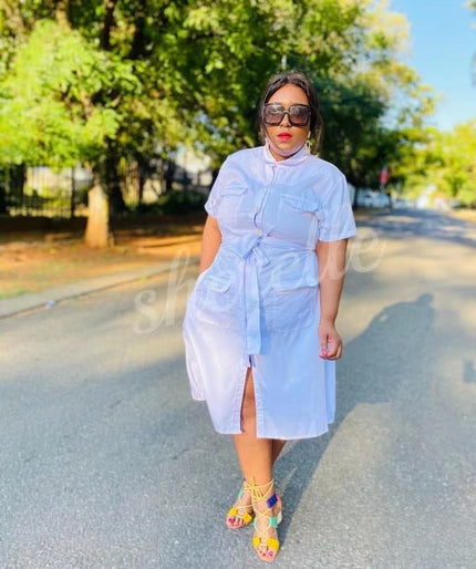White shirt dress with tie waist, chest patch pockets, short sleeves, midi length