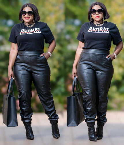 Black faux leather pants with stretch waist and cuffed ankles, jogger style