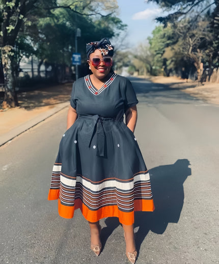 V-neck belted midi dress with striped hem bands, orange hem accent and bow tie