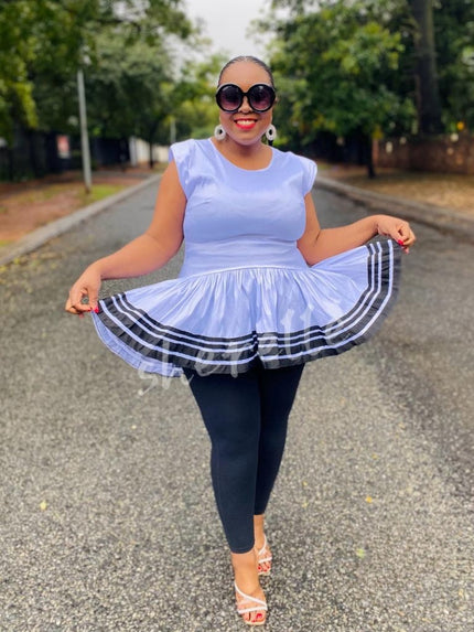 Light blue V-neck flared hem top with striped ruffle border