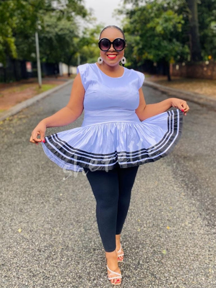 Light blue V-neck flared hem top with striped ruffle border