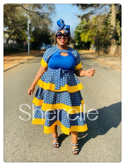 African print tiered dress with headwrap, blue and yellow patterned ruffle skirt