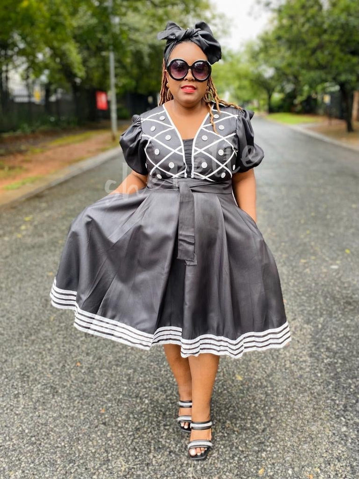 Black puff sleeve A-line midi dress with embroidered bodice and striped hem