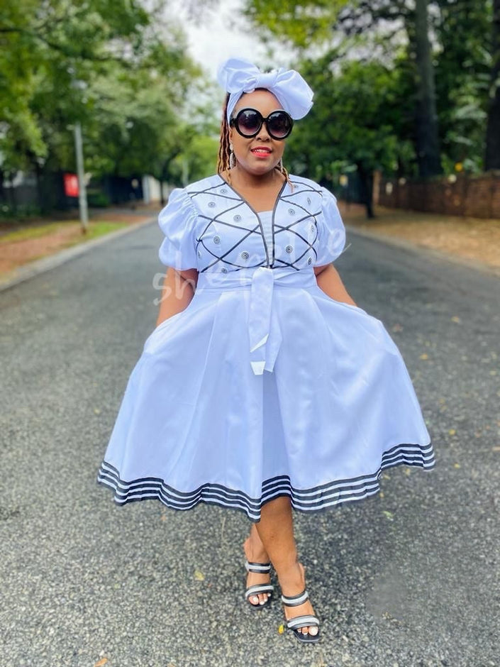 White puff sleeve A-line midi dress with embroidered bodice and striped hem