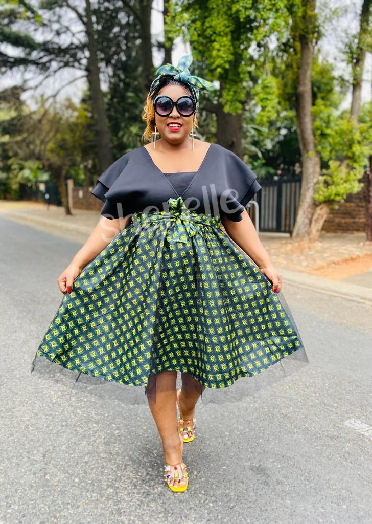 V-Neck Flared Dress with Geometric Patterned Skirt and Bow Waist Detail