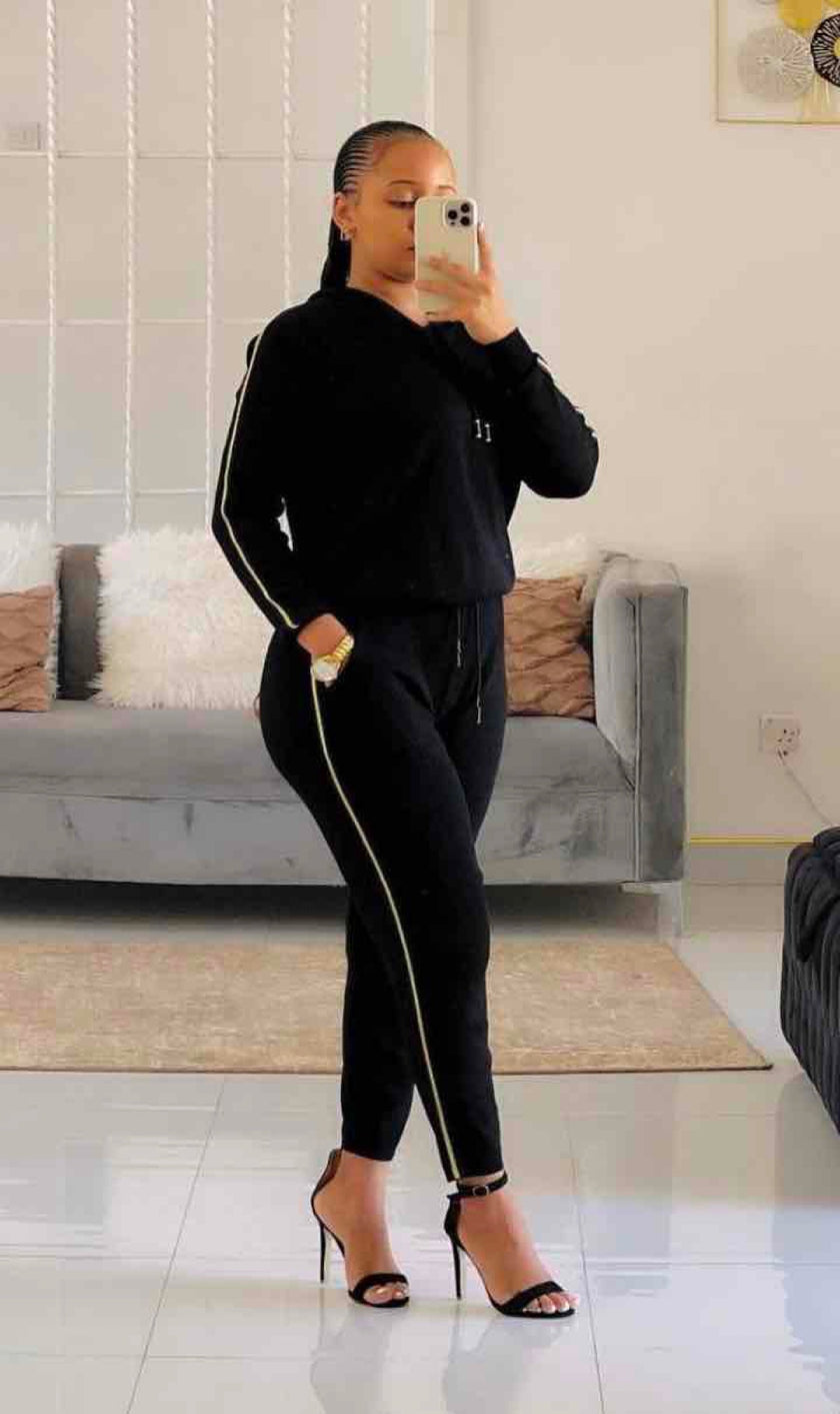 Sporty zippered hoodie paired with striped long pants, perfect for casual athletic wear