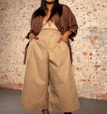 Tan high-waist wide-leg pleated trousers with belt loops